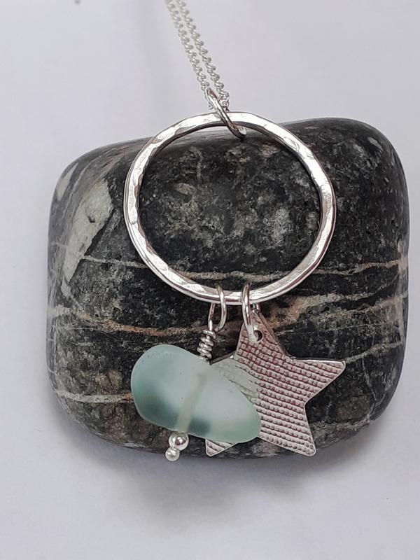 silver pendant with star and sea glass