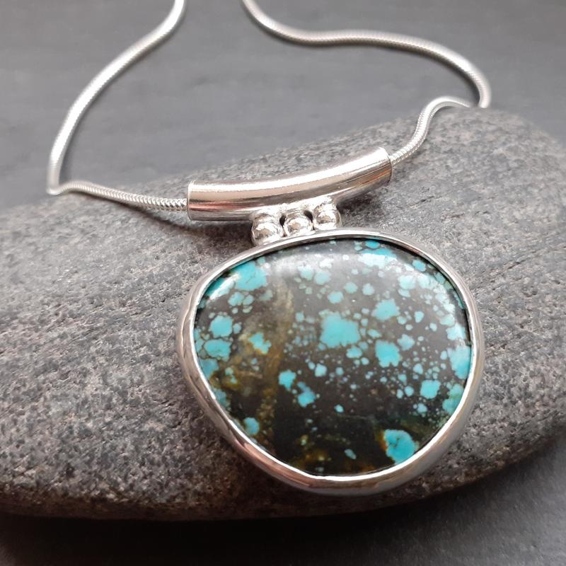 silver pendant with turquoise stone