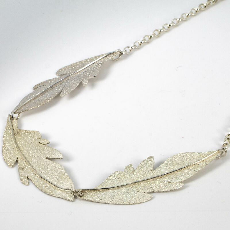 Sterling silver necklace with 3 long leaves and sandstone finish