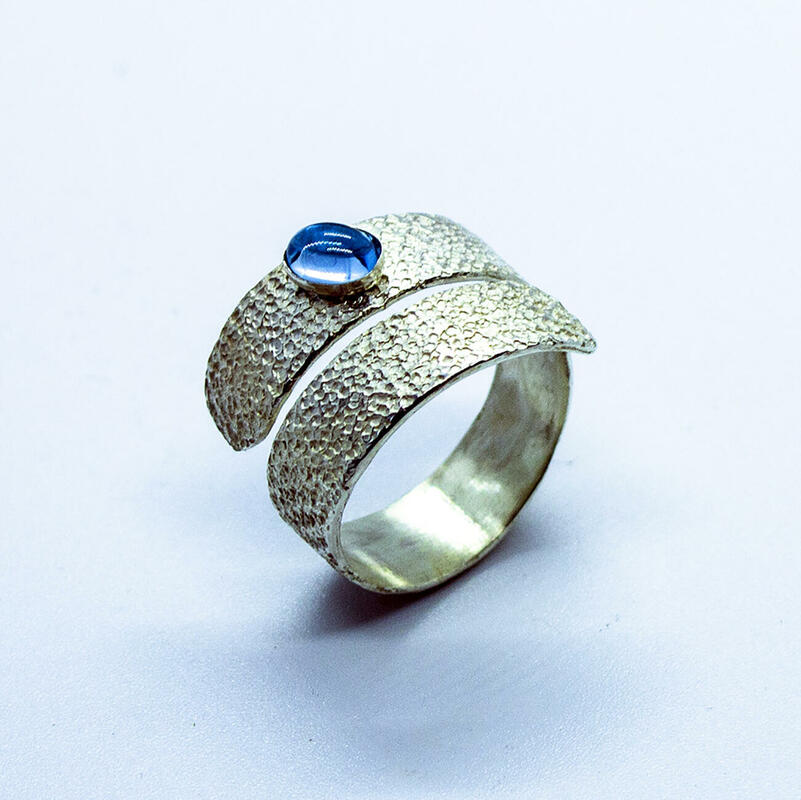 Wrap ring with blue topaz cabochon and sandstone finish