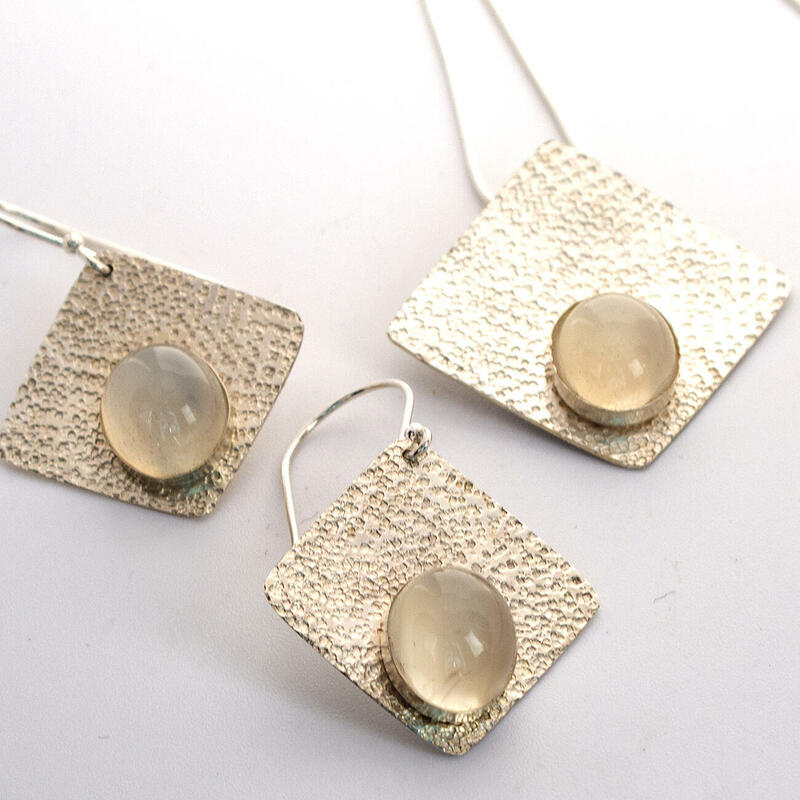sterling silver set with romboid pendant and drop earrings and very big white moonstones and sandstoned finish