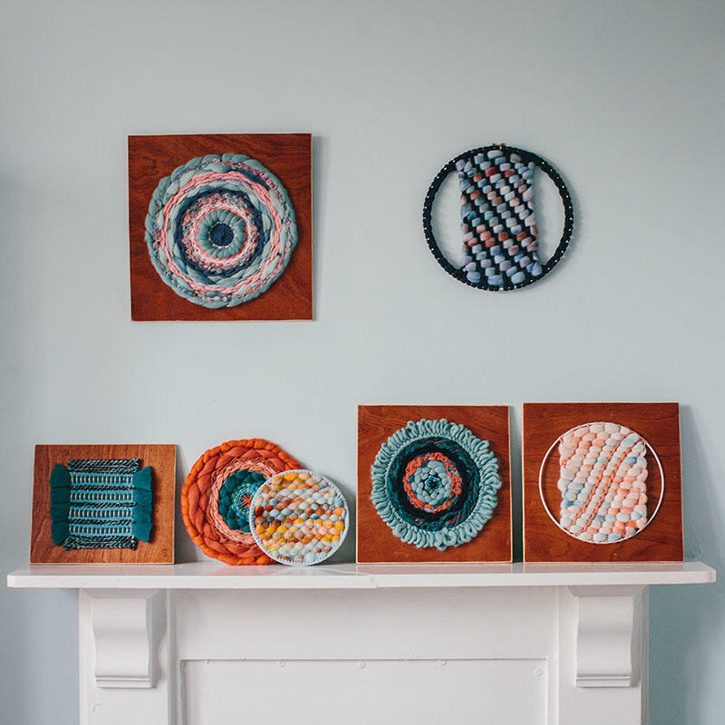 Handwoven circular artwork in blues and oranges