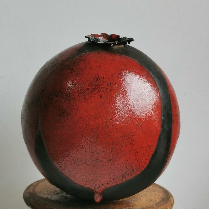red spherical pot with drip of red glaze