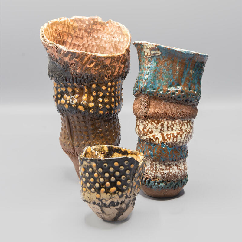 Small irregular-shaped pots with impressed decorated