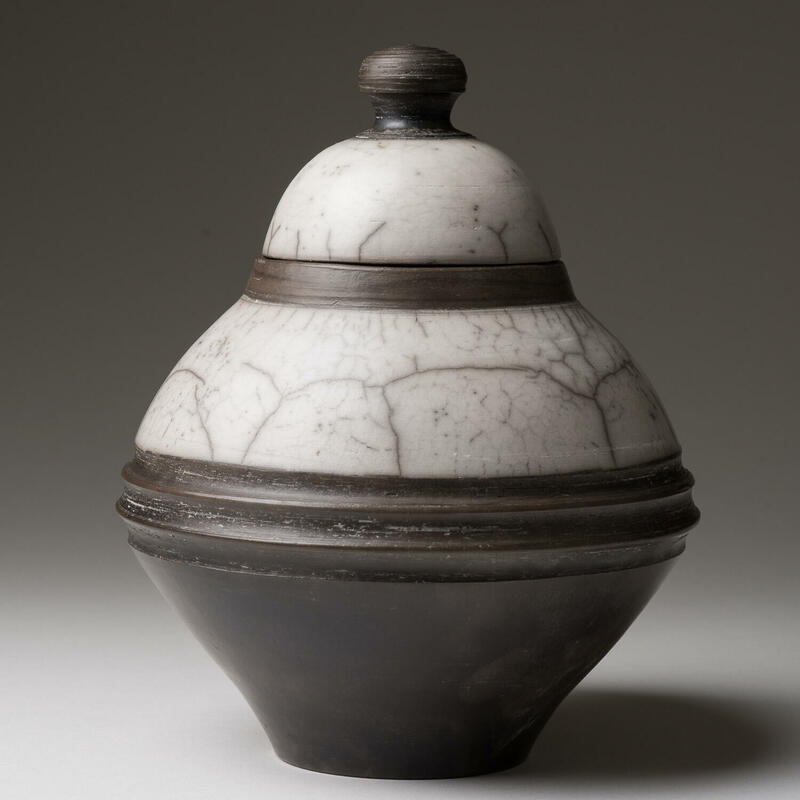 Naked raku urn with lid.