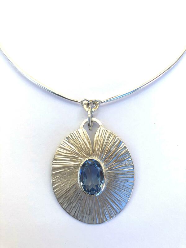 Silver pendant with blue faceted stone