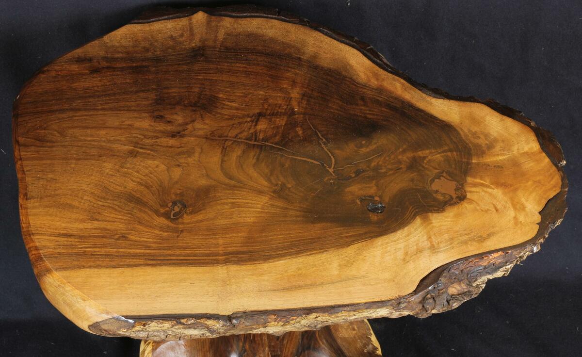 Walnut tree-table top illustrating the character and grain of walnut wood