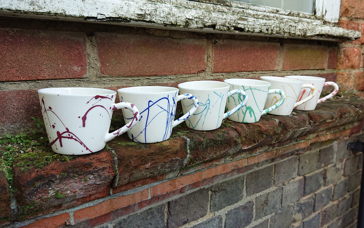 Selection of mugs in varied colours, parian porcelain