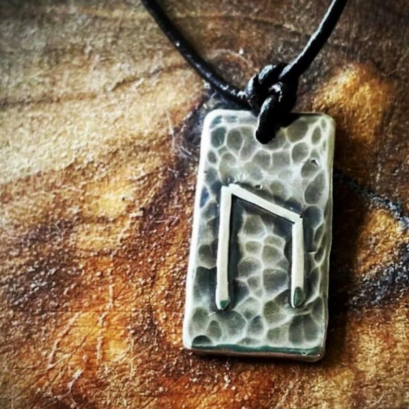 The Rune.A hand smithed silver lozenge textured over Sarsen Stone Known throughout millennium for its magical properties of divine love and solid energy.  Adorned with a silver Uruz Rune