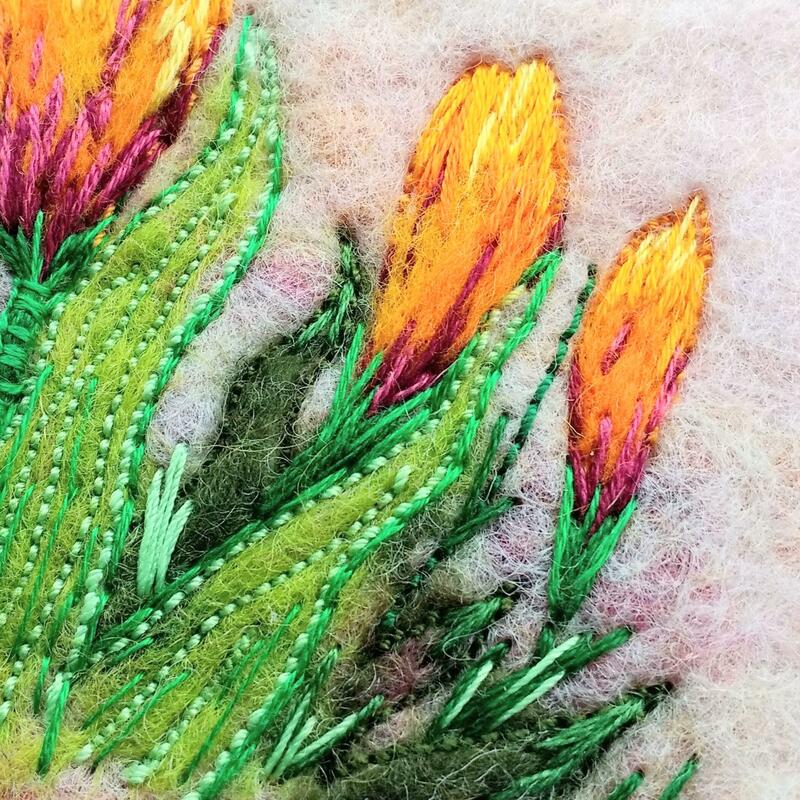 Felted wool, machine stitched and hand embroidered crocus. Bright and colourful.