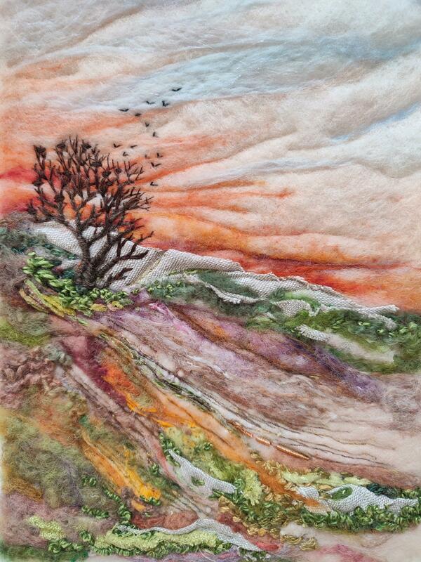 Hillside with tree at sunset. Felted wool, fabric collage, with embroidery. Dramatic.