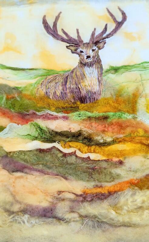 Hand embroidered stag standing proudly in a felted wool and fabric landscape. Regal.