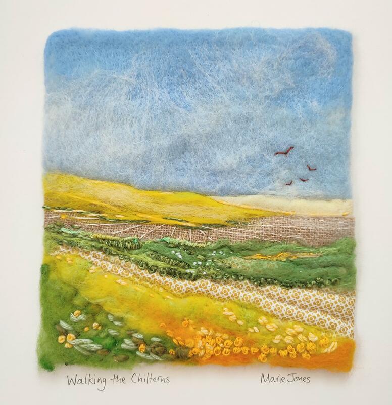 Felted wool, fabric and embroidery. Summer fields in yellows with blue sky and red kites in the distance. Cheerful.