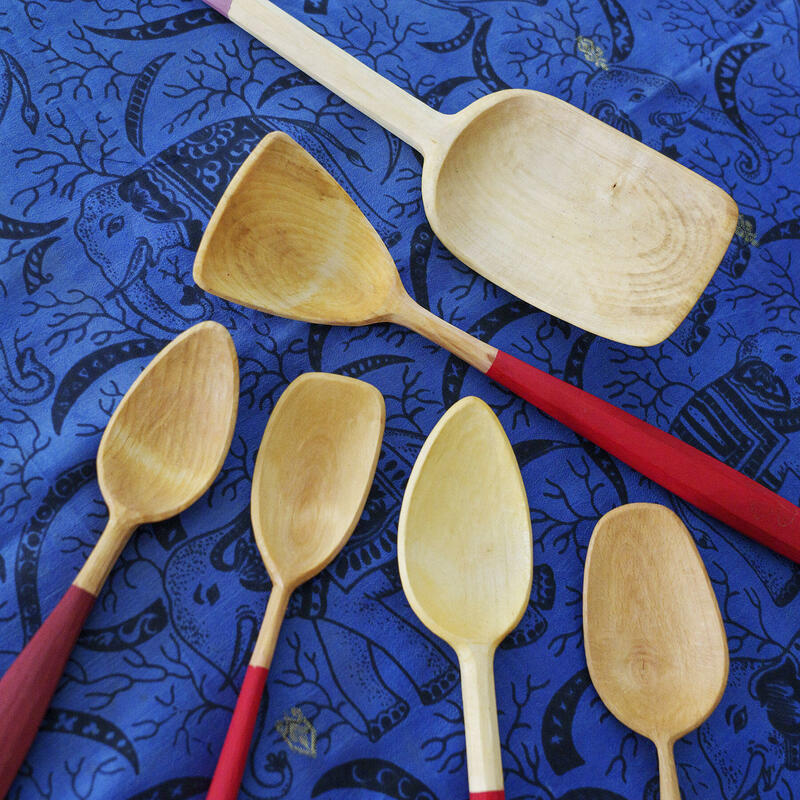 A selection of hand-carved wooden spoons, by Michael J. Amphlett. Clockwise from the top, two in Horse chestnut, Beech, Sycamore, Apple and Birch.