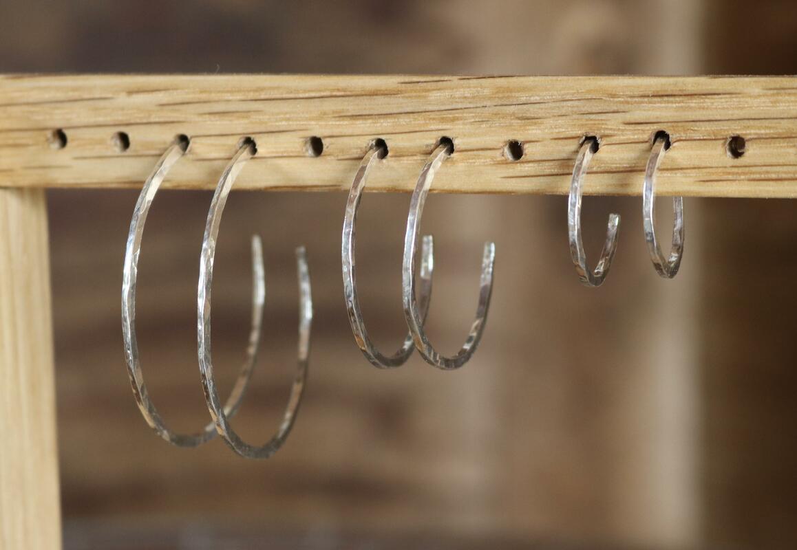 Sterling silver hammered hoop earrings in a variety of sizes 