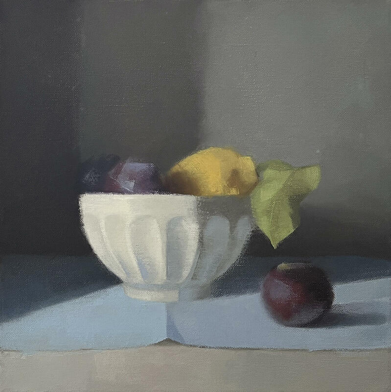 Latte Bowl, an oil painting by Claire Venables. This painting has a calm stillness. It depicts a latte bowl, filled with lemons and plums. One plum has fallen out and sits in the foreground. The plum's deep colour is highlighted by the dusty blush of the fruit.
