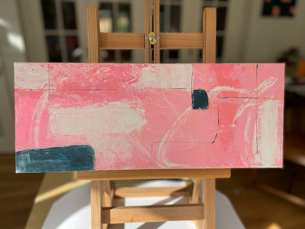 Mostly pink abstract painting, landscape format, seen on an easel