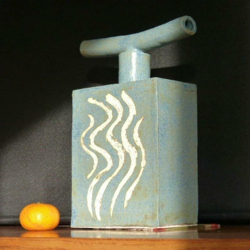 Flask with stopper: falling water, Japanese influenced motif against a green glaze background, 30cm tall.