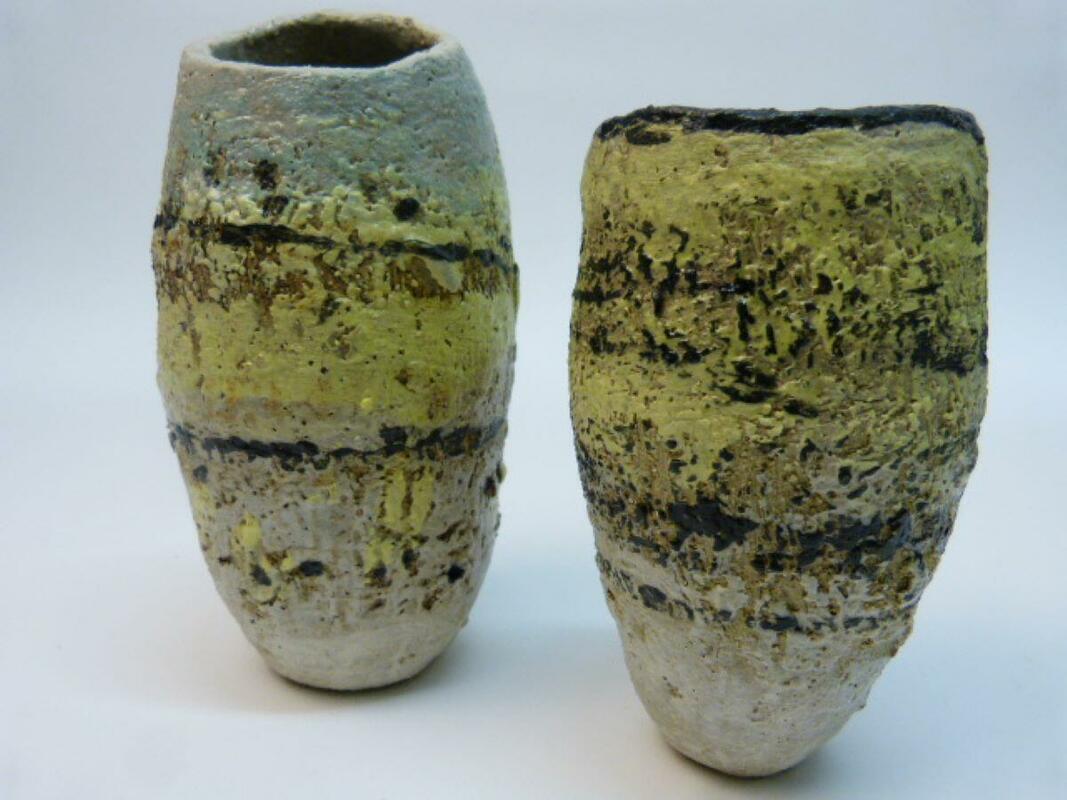 Two small vessels - 14cm and 18cm, with rugged, textured surfaces referencing geological strata.