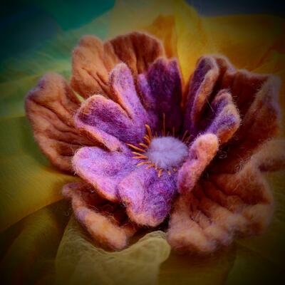 Wet felted flower with machine embroidery and hand stitched detail. Rich texture and colour.