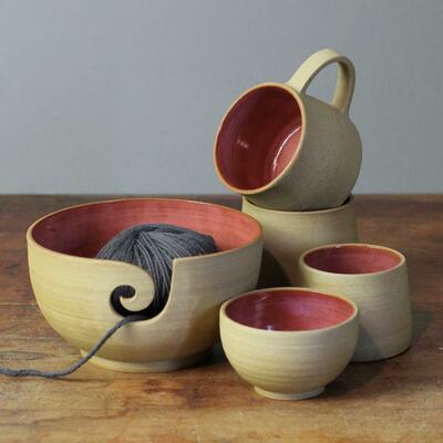 Wheelthrown ceramic bowls and mugs with pink interiors by Leigh Hicks