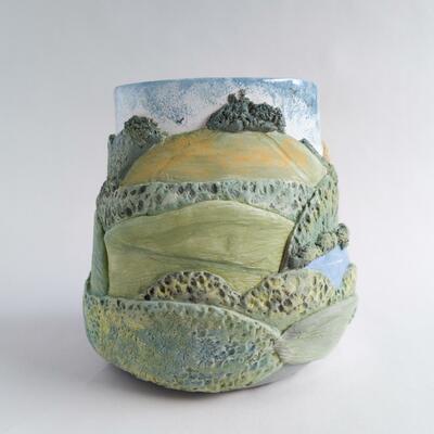 Ceramic vase featuring a scenic landscape design