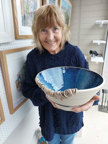 Alison with large blue Stoneware bowl with feature coils on the rim