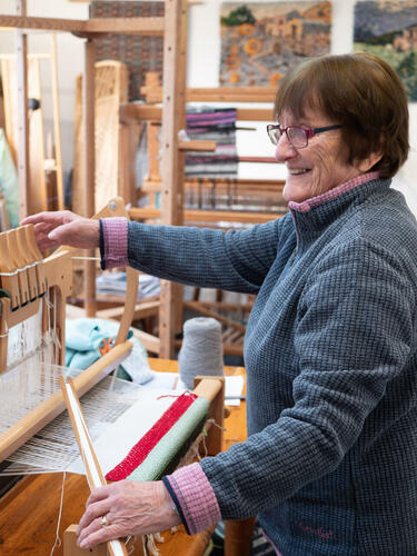 Anthea weaving in her studio at home