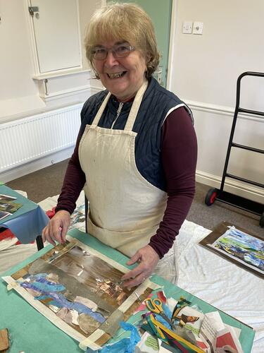 Sue King working on a collage piece