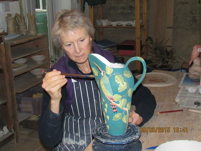 Painting a jug with underglazes