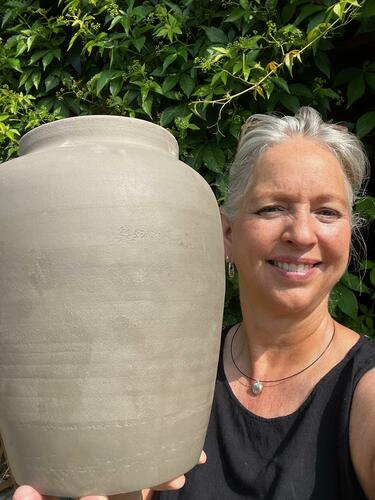 Alison holding a large pot 