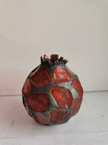 red and black spherical vessel with ragged rim