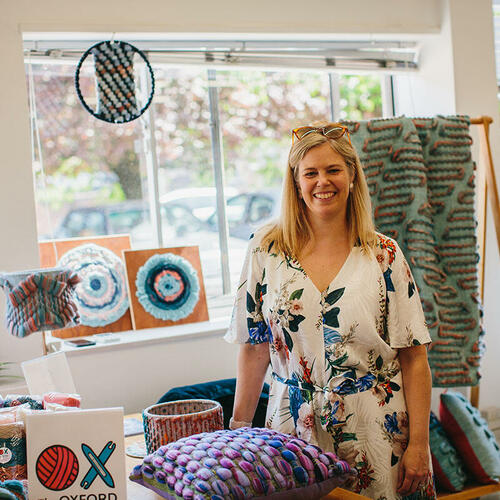 Cassandra Smith exhibiting her woven textile products during Artweeks 2023.