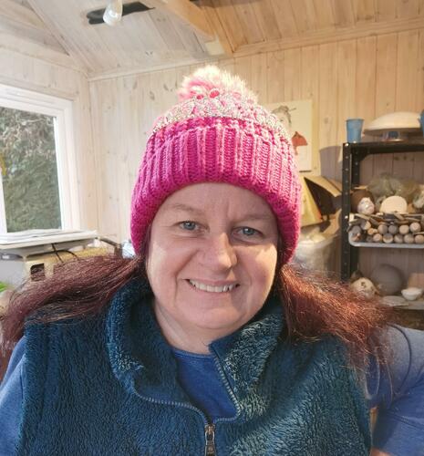 Debbie wearing a pink bobble hat with a tiara