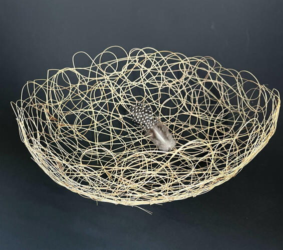 basket made of grass, with feather