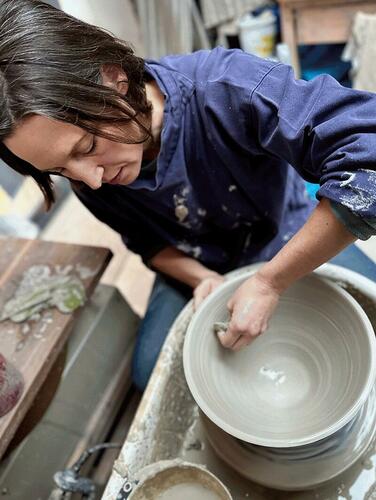 Helen Woolner throwing a bowl on the potter's wheel