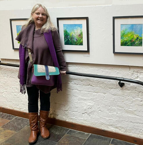Artist Julia Ogborne with some of her paintings