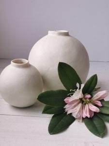 Debbie Page OCG, WOA: 2 spherical white pots, one small, one large, with pink rhododendron flower
