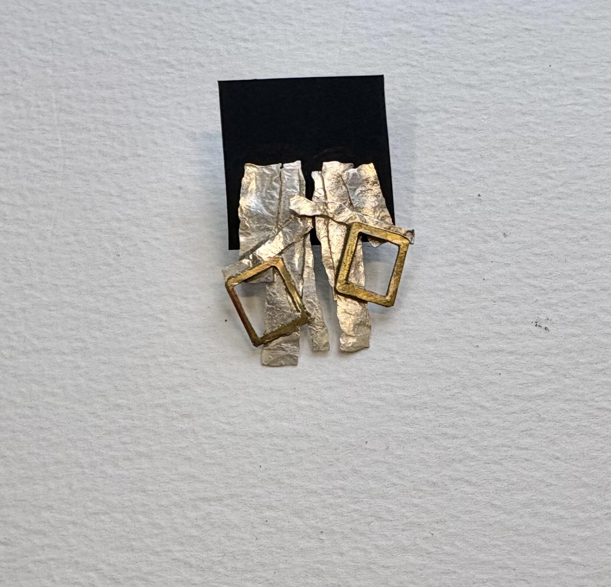 Jane Griffiths: Asymmetrical layered earrings in textured sterling silver and brass