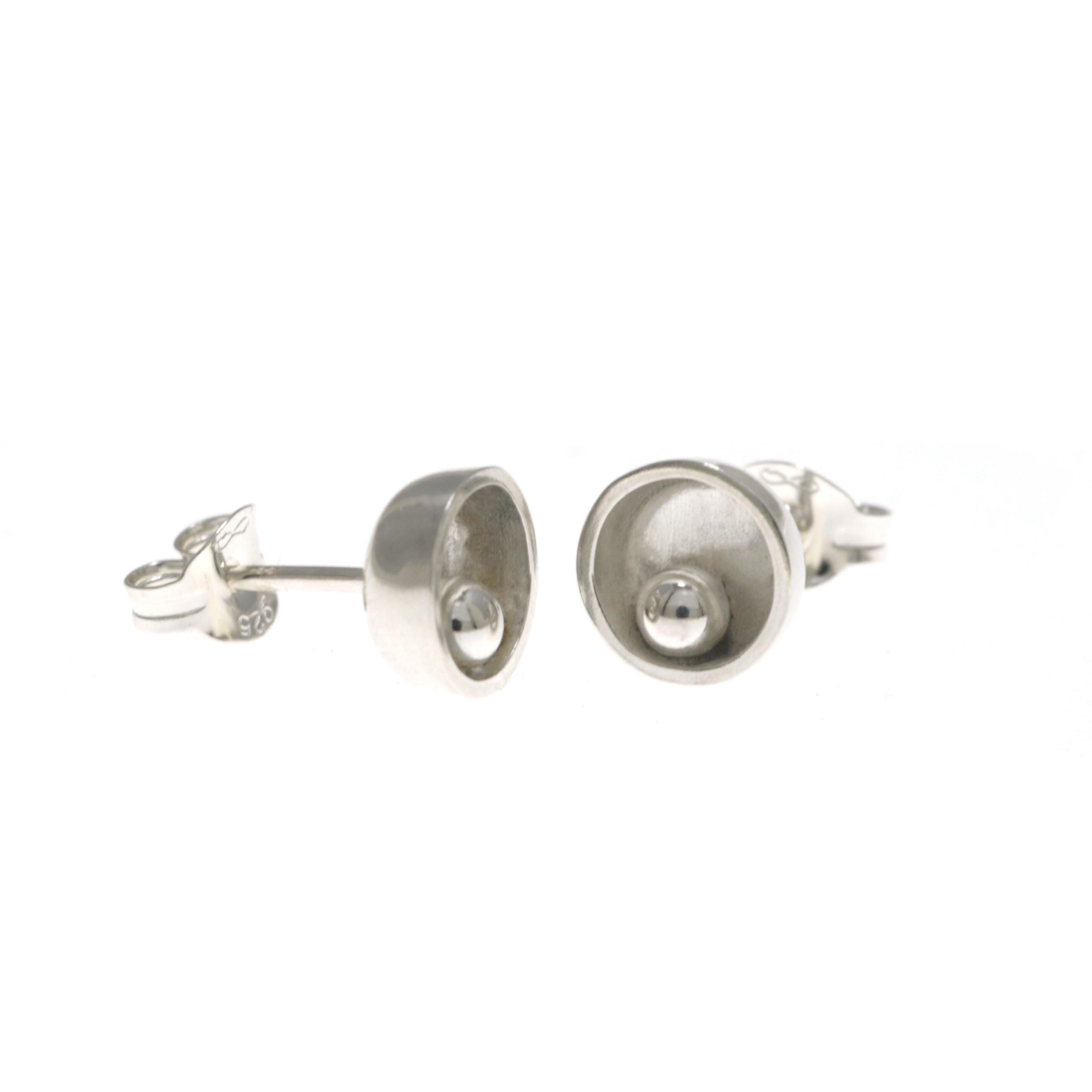 Machi de Waard: Machi de Waard open pod with silver ball earrings