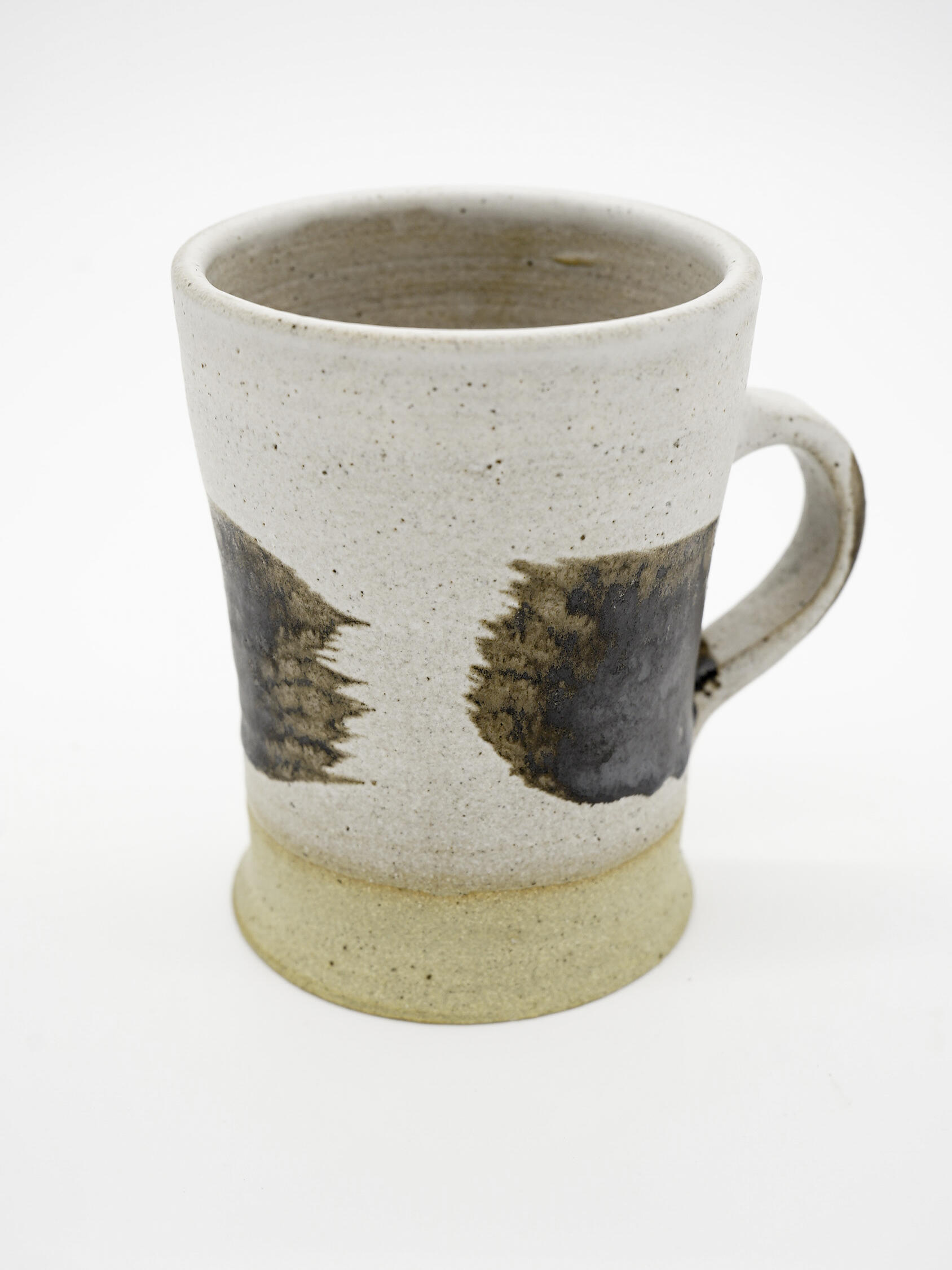 Nigel Edwards: I had made previous oxide and glaze design test mug thrown in Special Fleck Stoneware clay body. The results were rewarding and reminiscent of work that I witnessed in the 60’s and 70’s of my youth. I had made previous oxide and glaze design test mug thrown in Special Fleck Stoneware clay body. The results were rewarding and redolent of work that I witnessed in the 60’s and 70’s of my youth, the form of the mugs together their unique gestural motifs are reminiscent of that great progressive period.