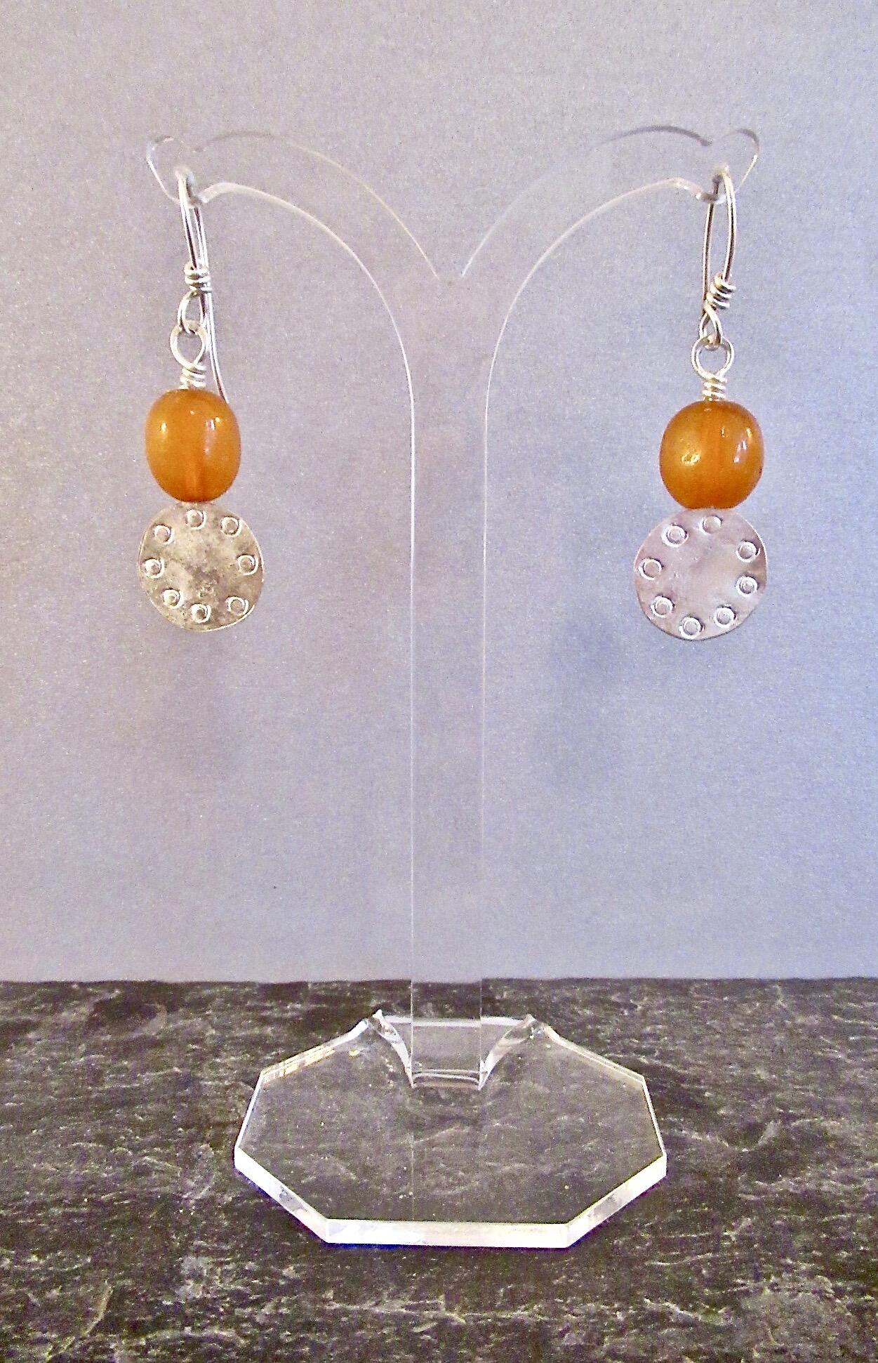 Tony Thomson: Tony Thomson Earrings: amber and silver round decorated disc