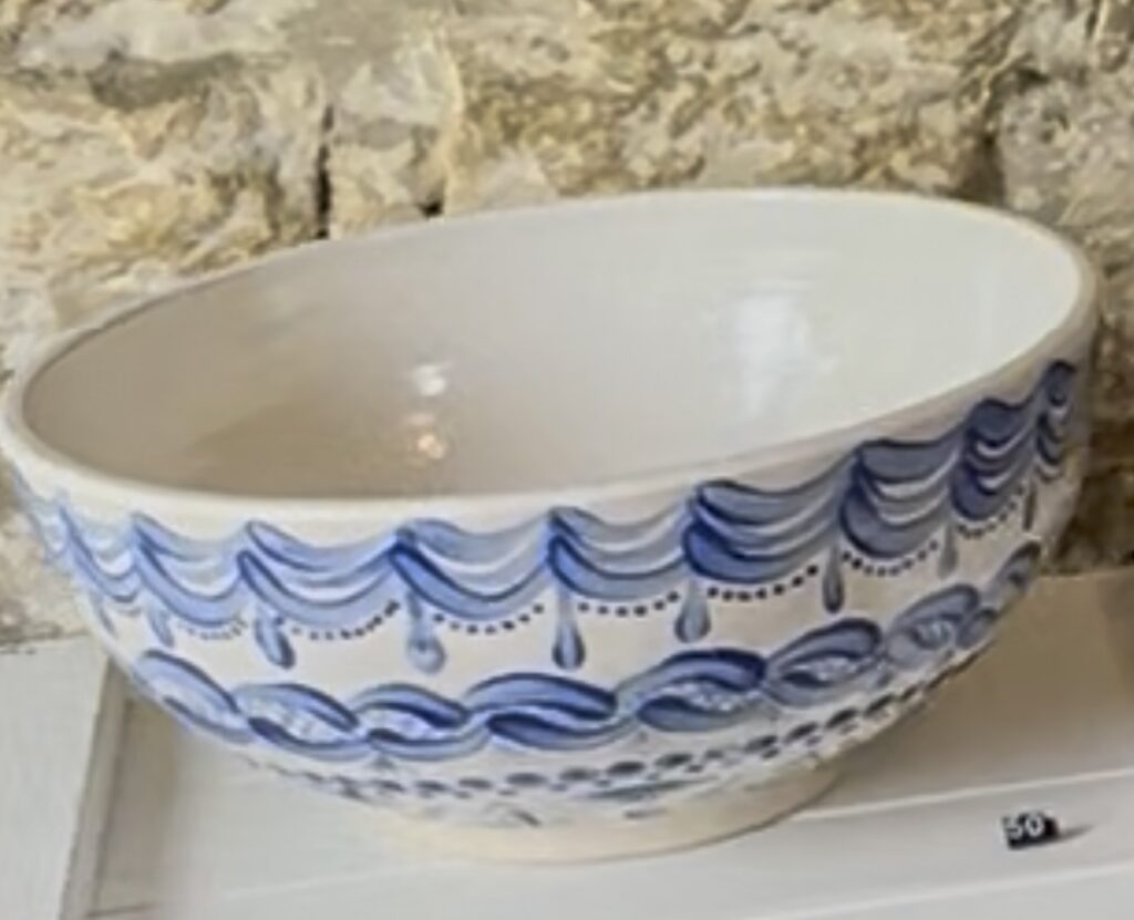 Hand thrown stoneware bowl with folk-inspired hand painted blue decoration on the outside