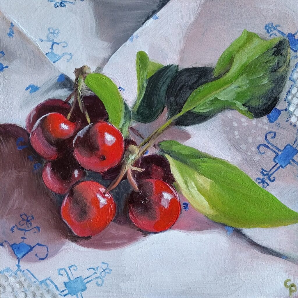 The painting depicts glossy crab apples on delicately embroidered white linen