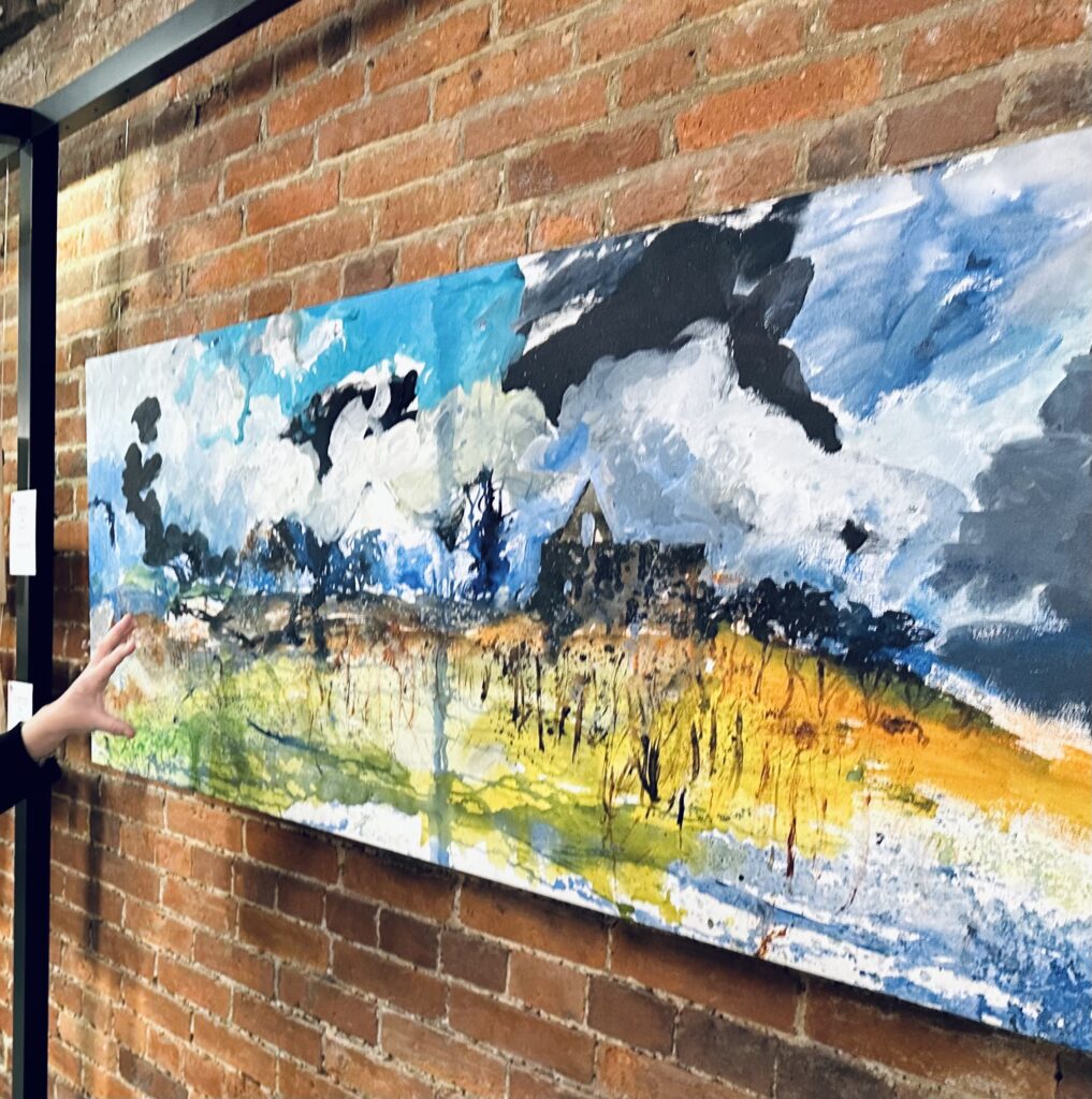 Large abstract landscape painting on a brick wall