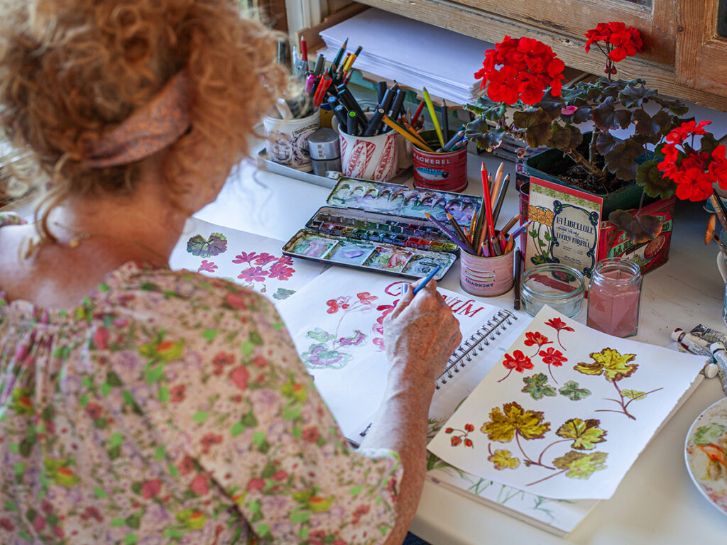 Fay painting in her garden studio