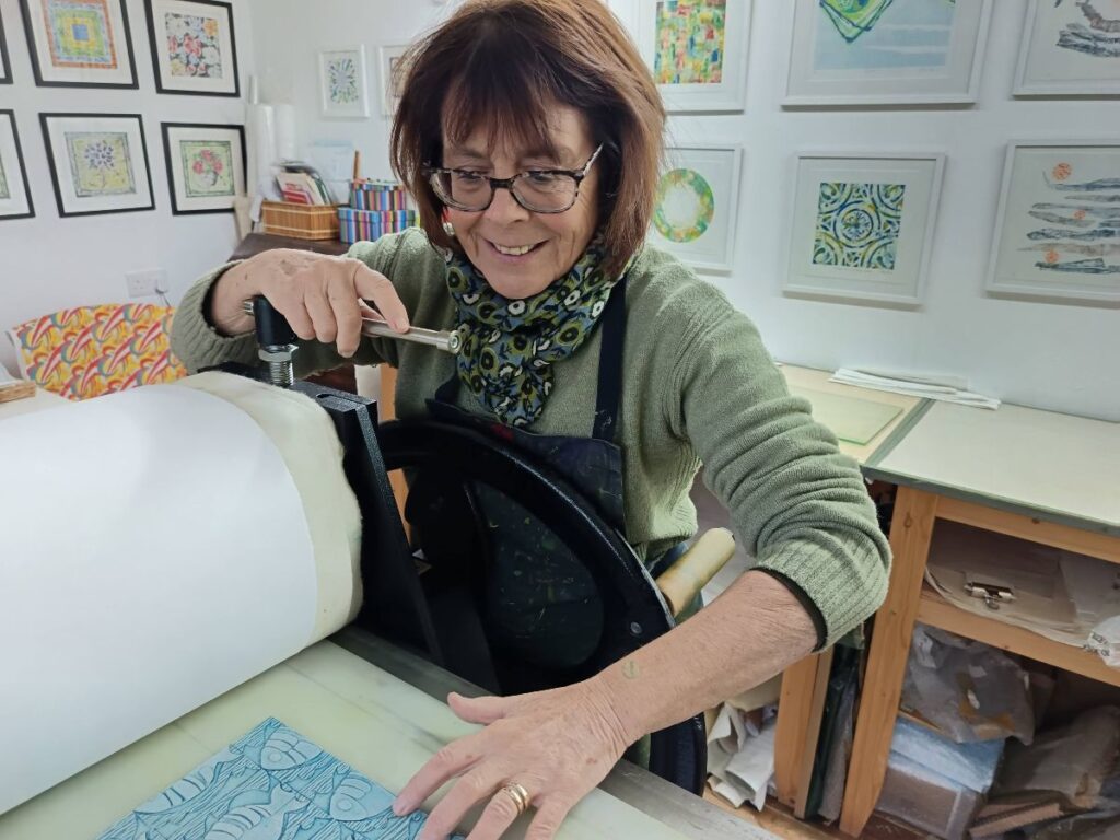 In my garden studio in Thame, working on my etching press