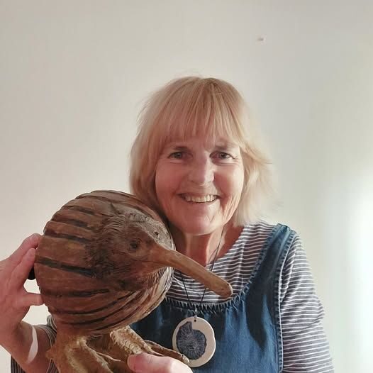 Alison Holmans with handbuilt/wheelthrown kiwi  and porcelain pendant
