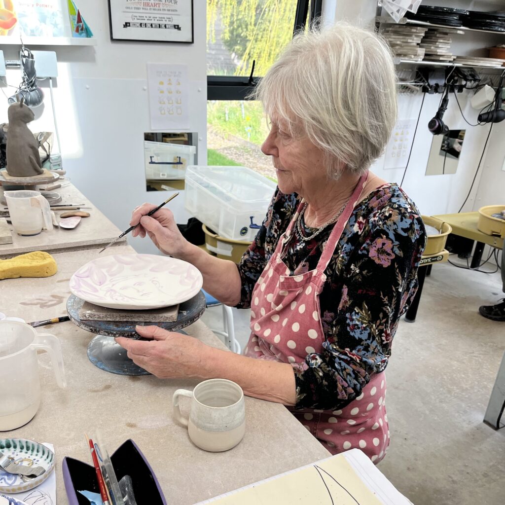 working on a majolica plate in my ceramics class
