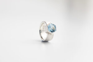 Emily Fermor: Silver band with hexagonal blue Topaz